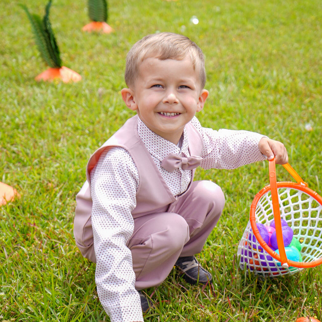 An image of a child collecting easter eggs at Lighthouse Baptist Church in Theodore, AL.
