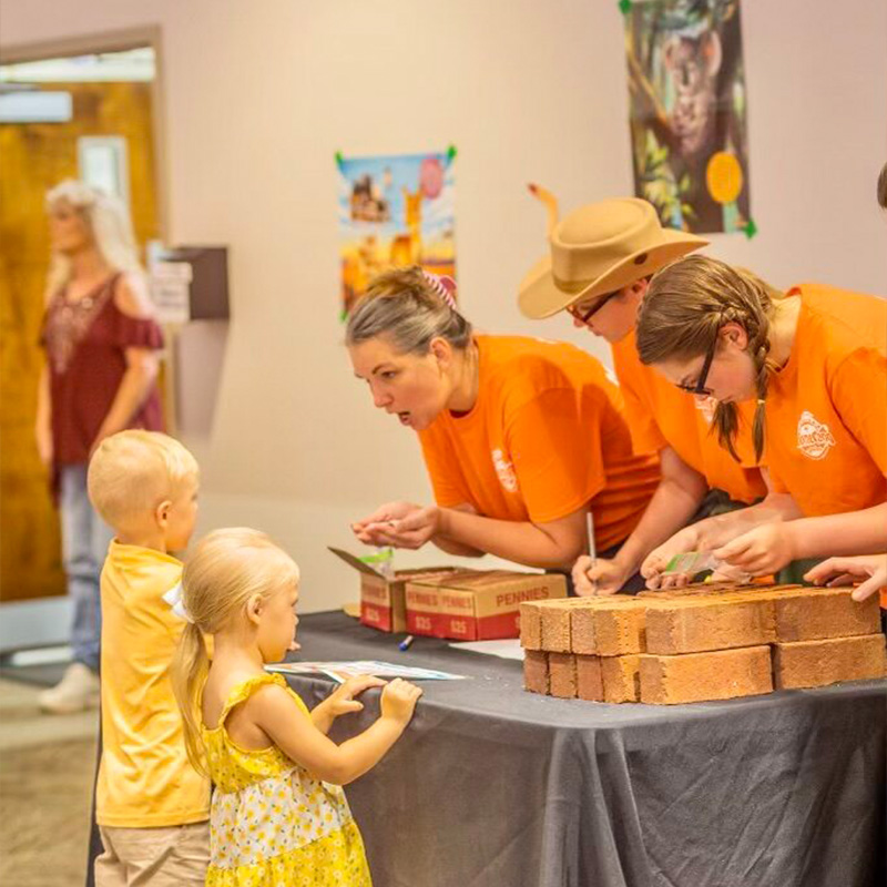 An image of workers helping children at Lighthouse Baptist Church's VBS in Theodore, AL.